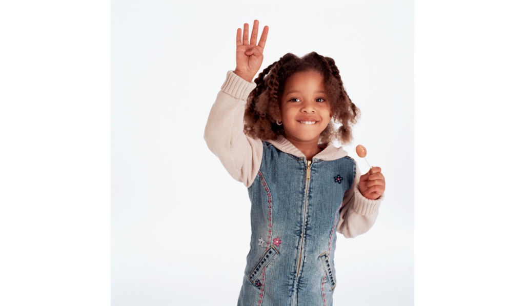 Student holding up four fingers to play talking math hands.